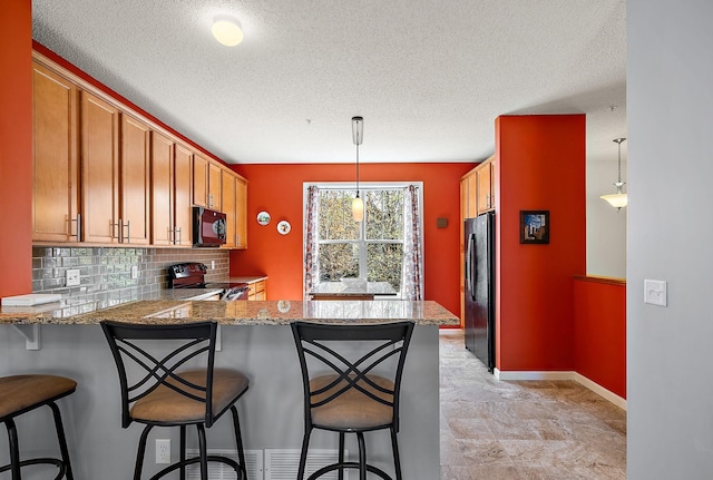 9668 Unity Ln N, Brooklyn Park, MN 55443 - kitchen featuring black appliances, a textured ceiling, a peninsula, tasteful backsplash, and light stone counters