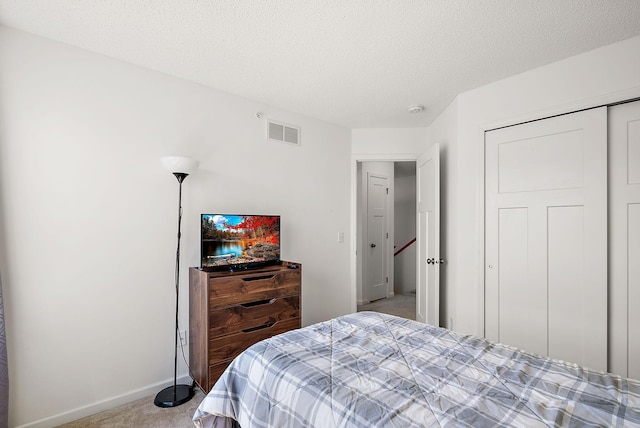 9668 Unity Ln N, Brooklyn Park, MN 55443 - bedroom featuring carpet flooring, baseboards, a textured ceiling, and a closet