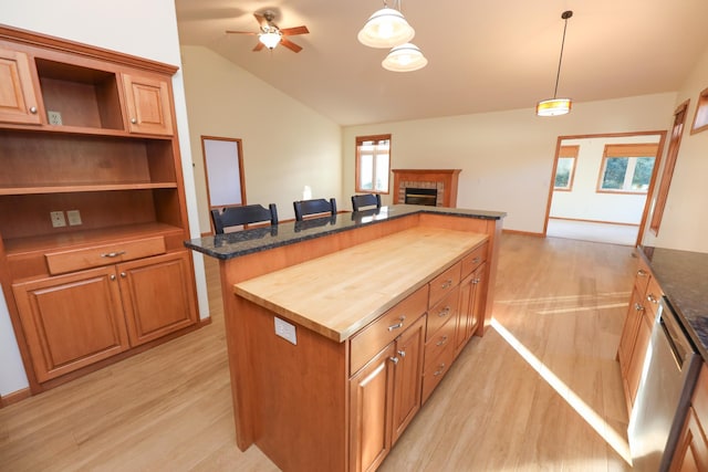 kitchen with wooden counters, a center island, ceiling fan, pendant lighting, and light hardwood / wood-style flooring