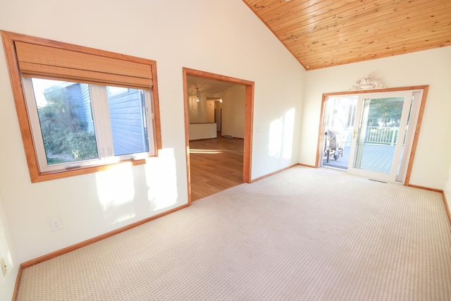 carpeted empty room featuring lofted ceiling and wood ceiling