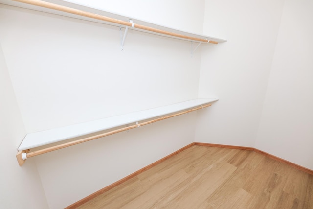 spacious closet featuring hardwood / wood-style flooring