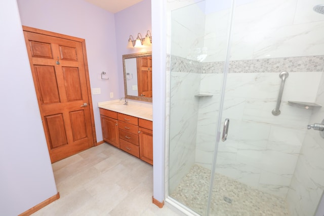 bathroom with a shower with shower door and vanity