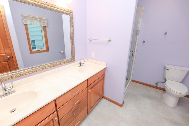 bathroom with vanity, a shower with shower door, and toilet