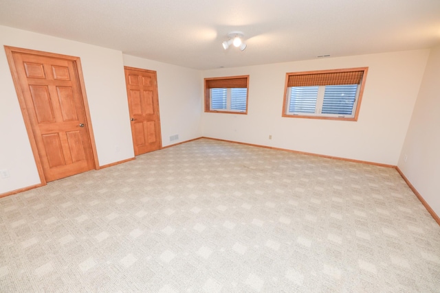 unfurnished bedroom featuring light carpet