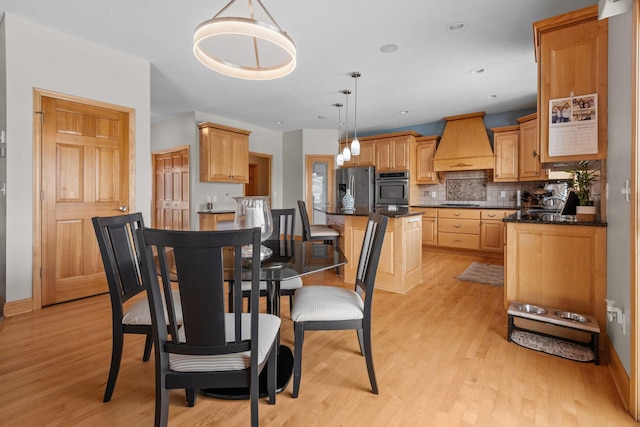 dining area featuring light wood-type flooring