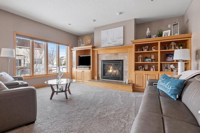 living room featuring a tile fireplace and a textured ceiling