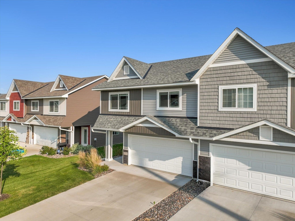 view of front facade with a garage and a front lawn