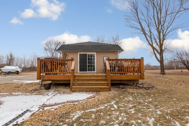 snow covered house featuring a wooden deck