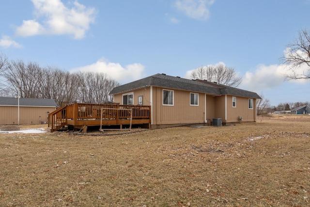 rear view of property featuring a wooden deck and central AC unit