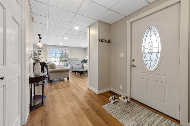 foyer with light hardwood / wood-style flooring and a paneled ceiling