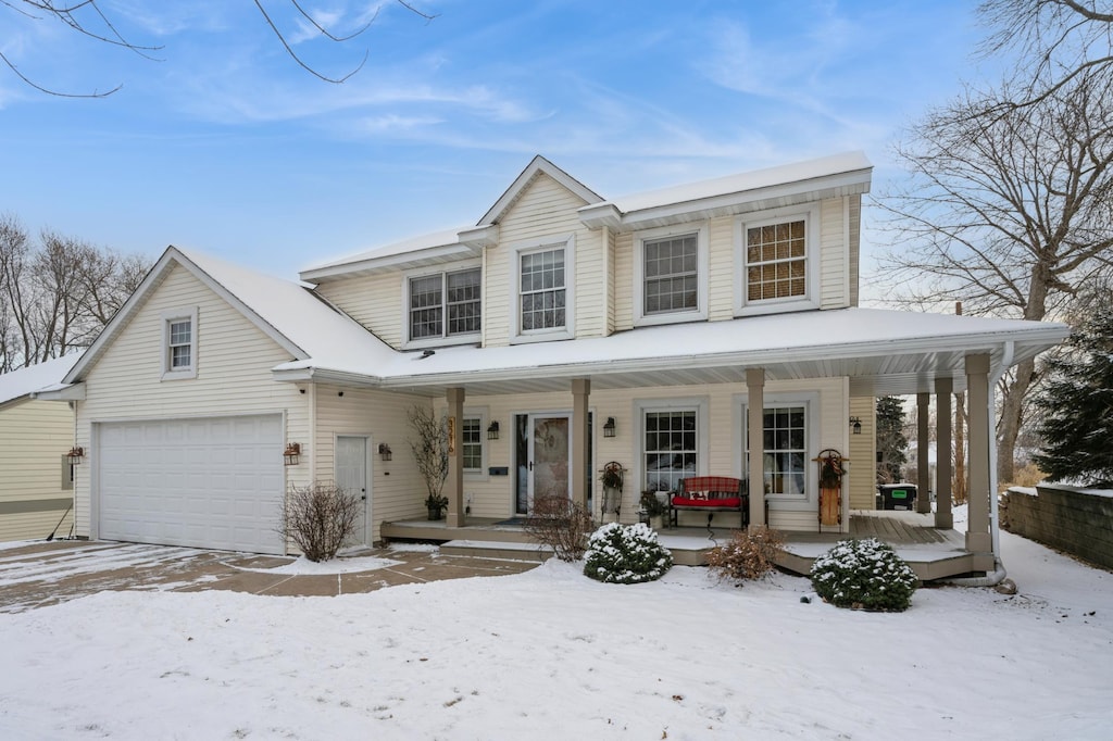 view of front of house featuring covered porch and a garage