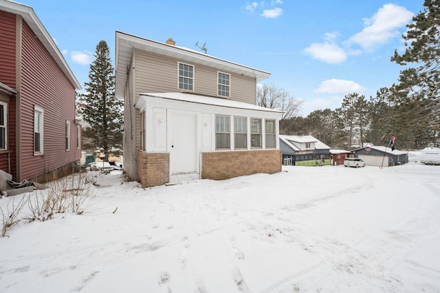 view of snow covered rear of property