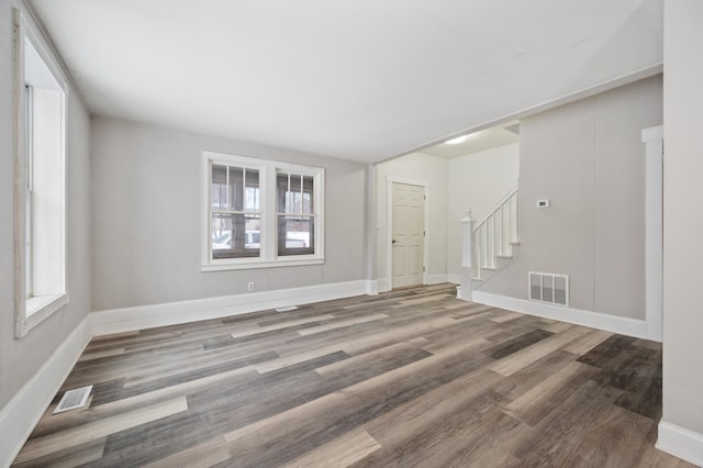 spare room featuring a healthy amount of sunlight and hardwood / wood-style floors