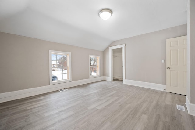 additional living space with lofted ceiling and light wood-type flooring