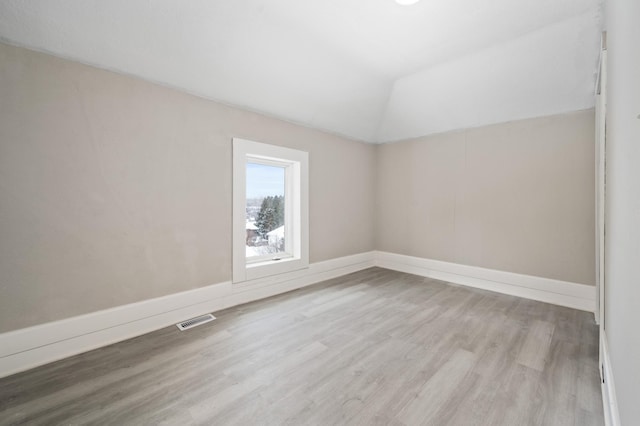 interior space with lofted ceiling and light hardwood / wood-style flooring