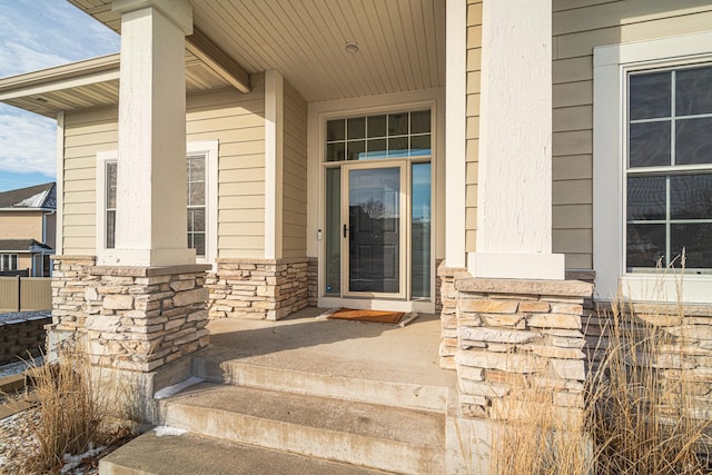 view of exterior entry featuring a porch