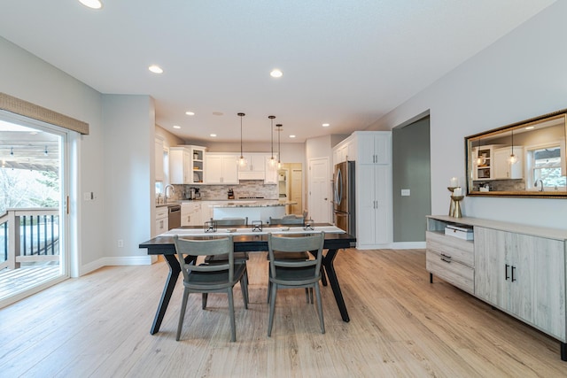 dining area with sink and light hardwood / wood-style flooring