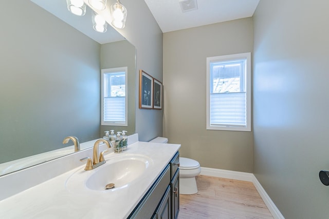 bathroom featuring vanity, hardwood / wood-style floors, and toilet