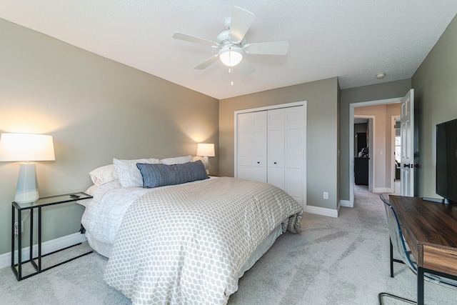 carpeted bedroom featuring a closet and ceiling fan