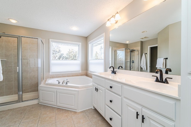 bathroom featuring tile patterned floors, plus walk in shower, a textured ceiling, and vanity