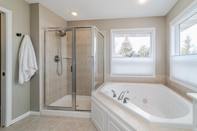 bathroom featuring tile patterned flooring, a textured ceiling, and separate shower and tub