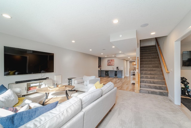 living room featuring a textured ceiling and bar area