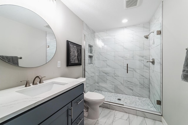 bathroom featuring vanity, toilet, and a shower with shower door