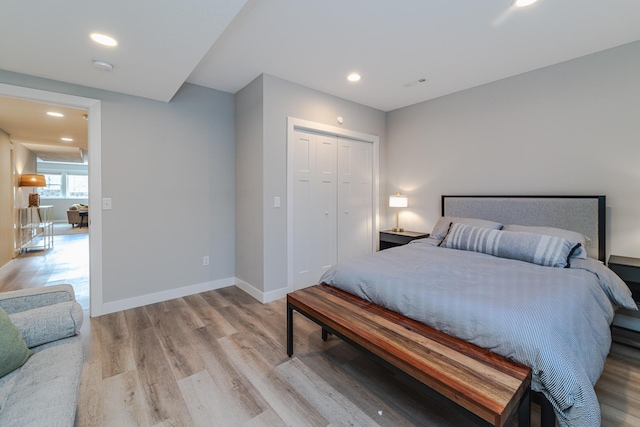 bedroom with light wood-type flooring and a closet