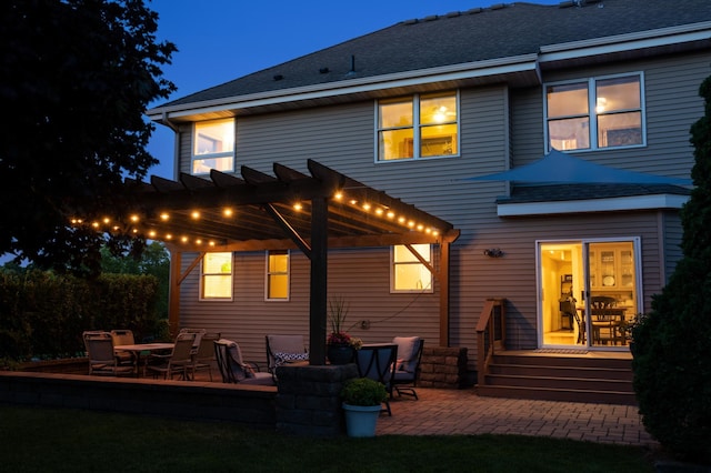 back of property featuring a patio area and a pergola