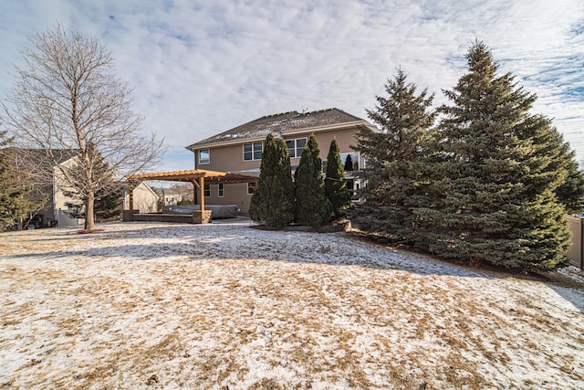 rear view of property with a pergola