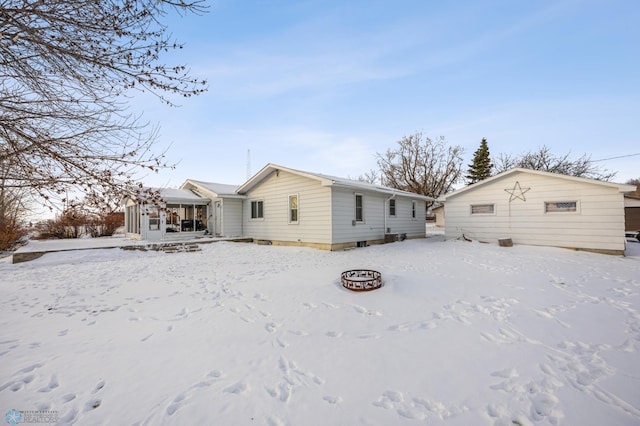 snow covered property featuring a fire pit