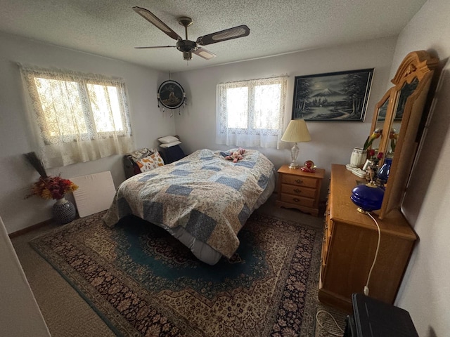 bedroom featuring a textured ceiling and ceiling fan