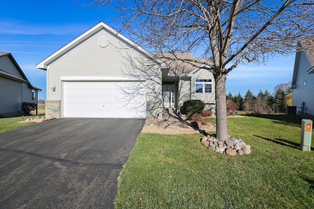 single story home featuring a front lawn and a garage