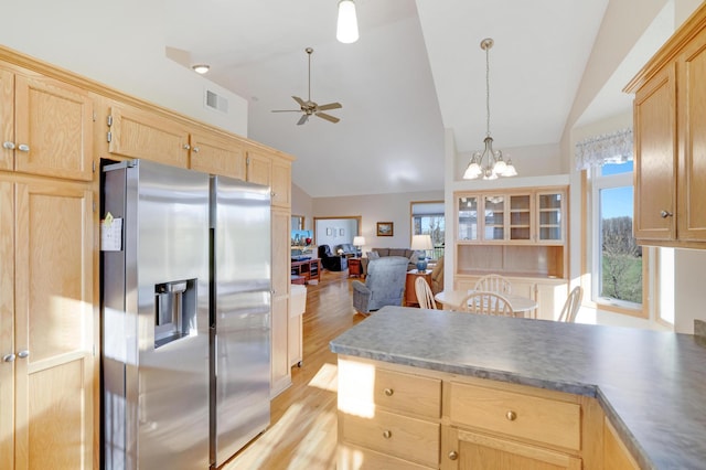 kitchen featuring stainless steel fridge, light hardwood / wood-style flooring, decorative light fixtures, lofted ceiling, and ceiling fan with notable chandelier