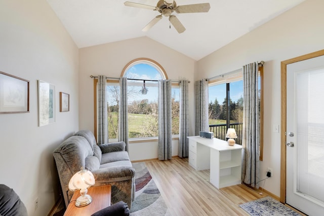 sitting room with light wood-type flooring, ceiling fan, vaulted ceiling, and a wealth of natural light