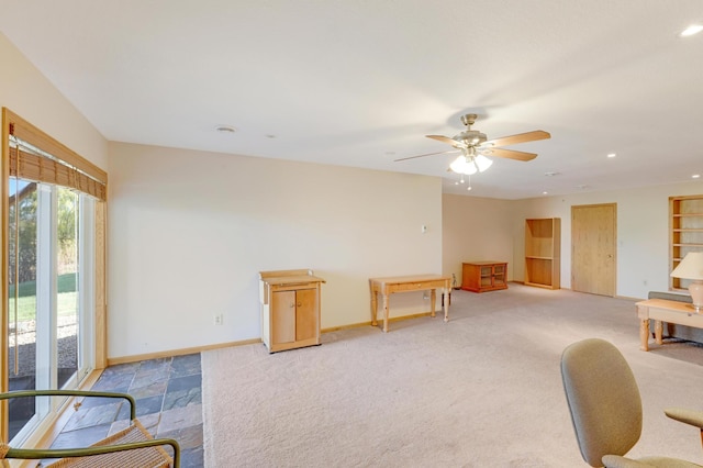 interior space with ceiling fan