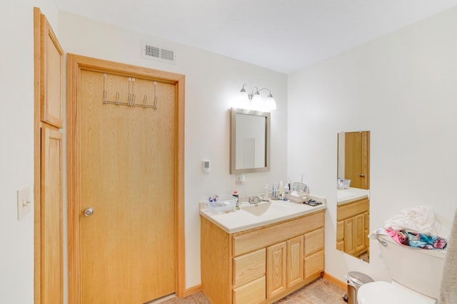 bathroom featuring toilet and vanity