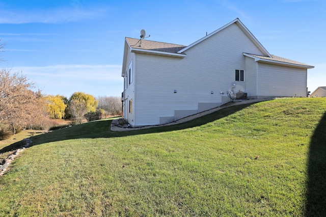 view of home's exterior featuring cooling unit and a yard