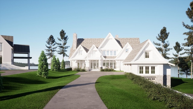 tudor house with french doors and a front yard