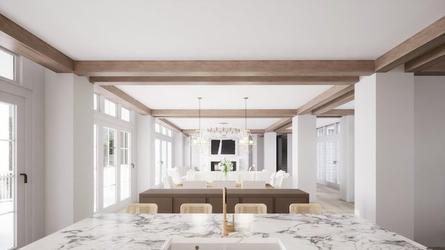 interior space featuring decorative light fixtures, light stone countertops, a breakfast bar, and beamed ceiling