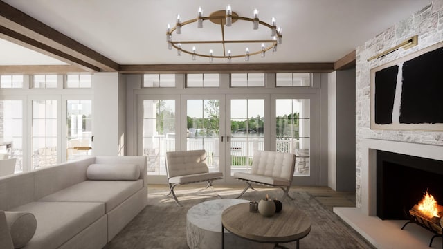 sunroom / solarium with a large fireplace, a notable chandelier, beam ceiling, and french doors