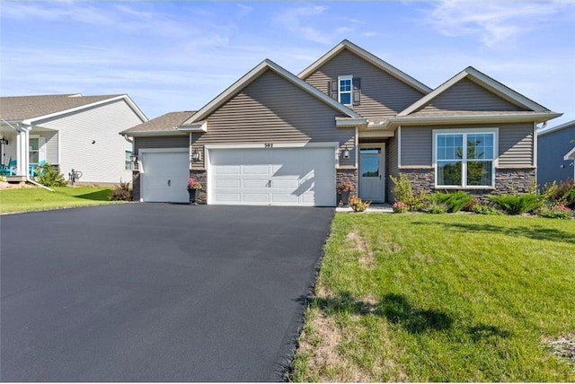 view of front of home featuring a garage and a front lawn