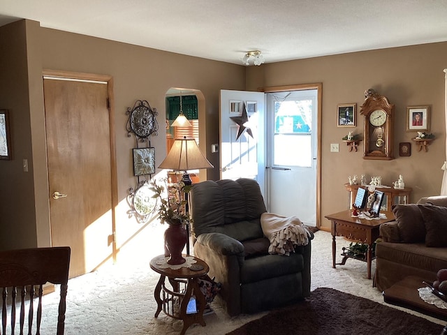 living area featuring light carpet