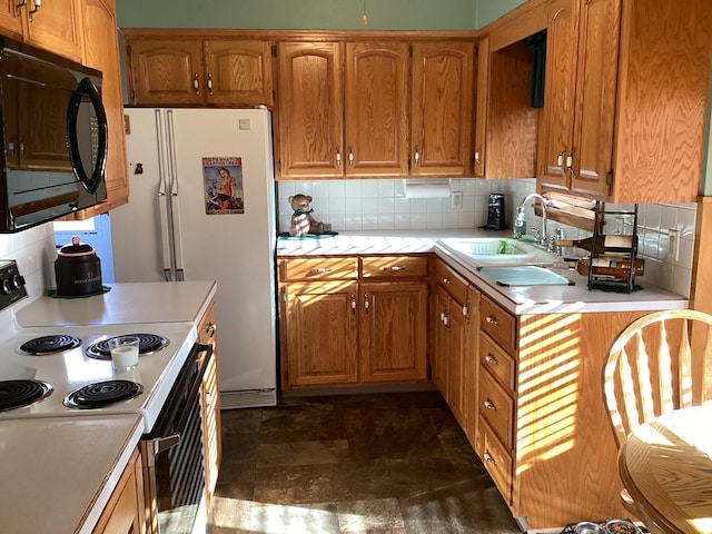 kitchen with white range with electric cooktop, backsplash, and sink