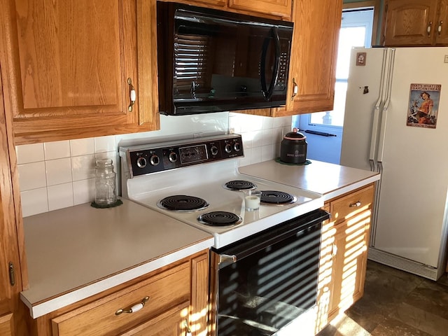 kitchen featuring backsplash and white appliances