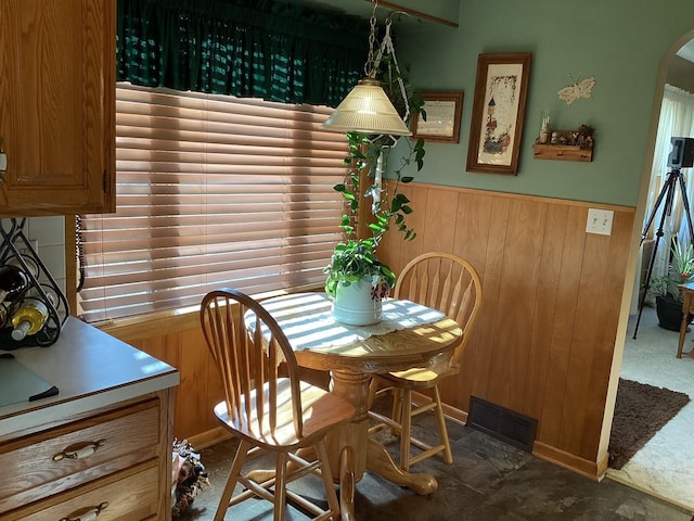 dining room featuring wood walls