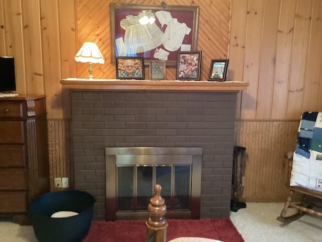 details with a brick fireplace, carpet floors, and wooden walls