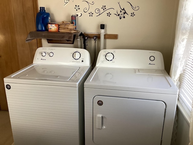 clothes washing area featuring separate washer and dryer