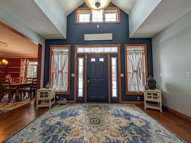 entryway featuring dark wood-type flooring and a high ceiling