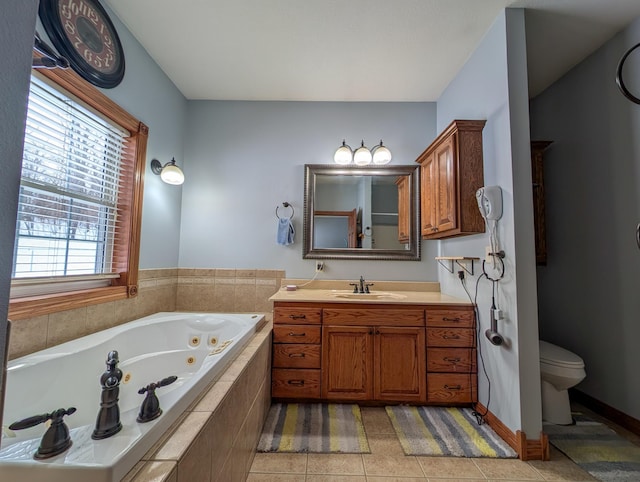 bathroom featuring tile patterned flooring, vanity, plenty of natural light, and toilet